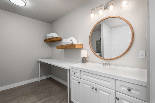 6012 Whispering Ln, Watauga, TX 76148 - bathroom with wood finished floors, vanity, and baseboards