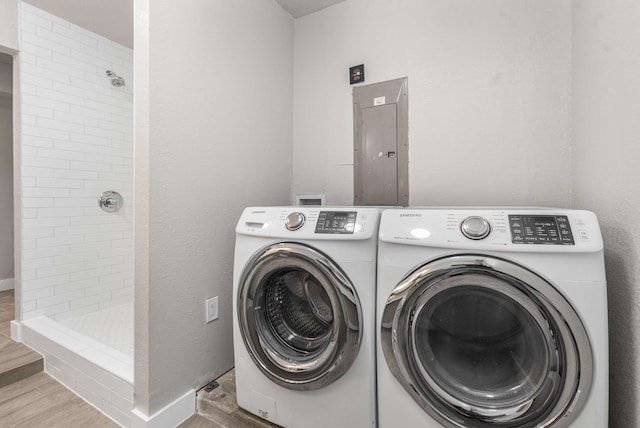 6012 Whispering Ln, Watauga, TX 76148 - laundry area with washing machine and dryer, electric panel, and wood finished floors