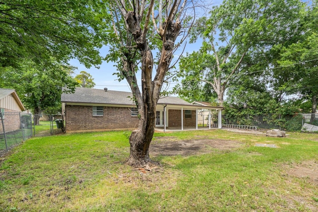 6012 Whispering Ln, Watauga, TX 76148 - back of house featuring brick siding, a patio area, a gate, and a shingled roof