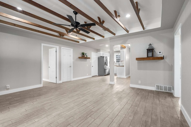6012 Whispering Ln, Watauga, TX 76148 - unfurnished living room featuring a ceiling fan, beamed ceiling, light wood-style flooring, and baseboards