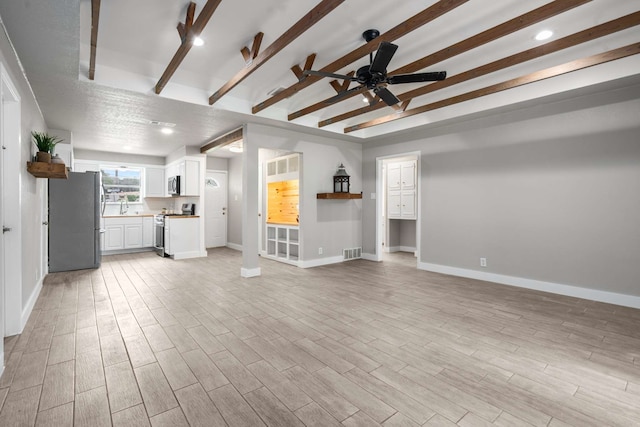 6012 Whispering Ln, Watauga, TX 76148 - unfurnished living room with beamed ceiling, baseboards, light wood finished floors, a sink, and a ceiling fan