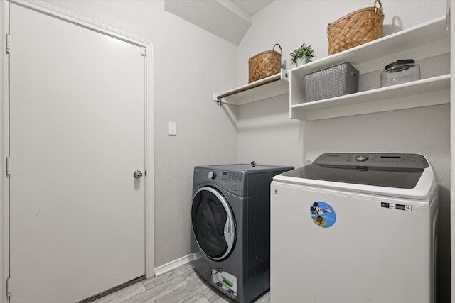 5305 Elmdale Dr, Watauga, TX 76137 - washroom featuring washing machine and dryer, light wood-type flooring, and baseboards
