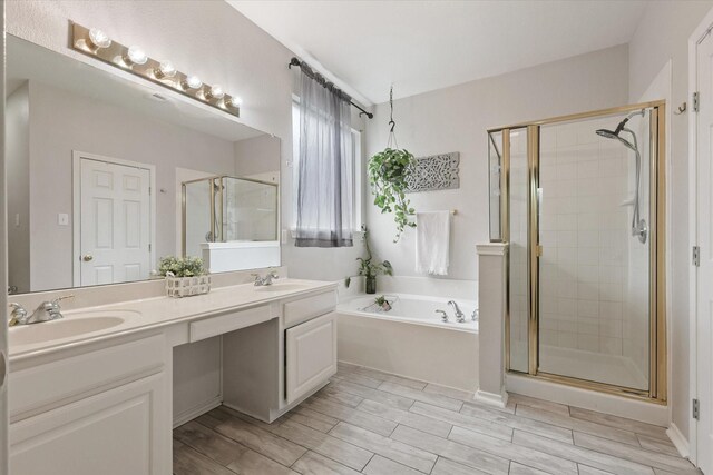 5305 Elmdale Dr, Watauga, TX 76137 - full bathroom with a stall shower, a garden tub, double vanity, and wood finish floors