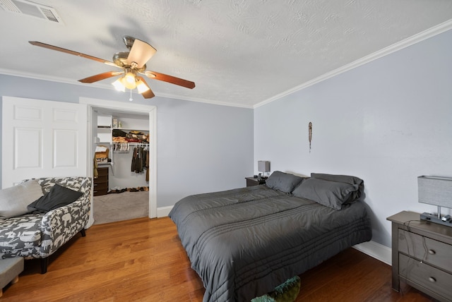 5005 Nevada Trl, North Richland Hills, TX 76180 - bedroom featuring wood finished floors, a closet, ornamental molding, ceiling fan, and baseboards