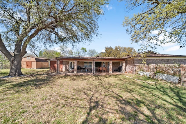 5005 Nevada Trl, North Richland Hills, TX 76180 - rear view of property with a lawn, brick siding, and a patio