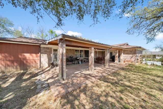 5005 Nevada Trl, North Richland Hills, TX 76180 - back of house featuring brick siding and a patio area