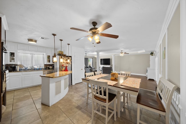 5005 Nevada Trl, North Richland Hills, TX 76180 - kitchen with ceiling fan, white cabinetry, a kitchen island, decorative light fixtures, and open floor plan
