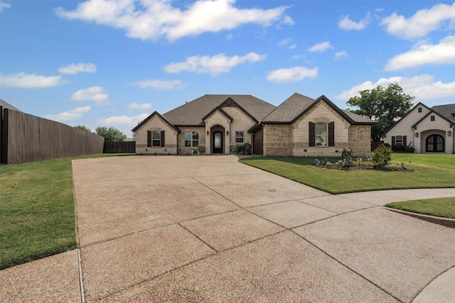 1103 Hilkiah Ct, Granbury, TX 76048 - french country inspired facade featuring stone siding, brick siding, and concrete driveway