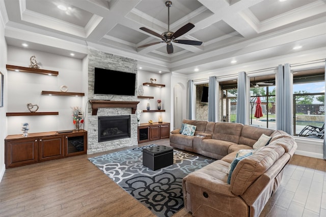 1103 Hilkiah Ct, Granbury, TX 76048 - living room with healthy amount of natural light, a ceiling fan, beam ceiling, a stone fireplace, and coffered ceiling
