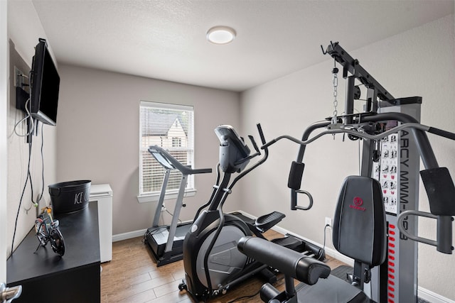 1103 Hilkiah Ct, Granbury, TX 76048 - workout room with wood finished floors and baseboards