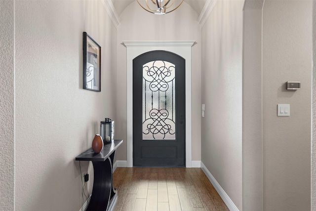 1103 Hilkiah Ct, Granbury, TX 76048 - entryway featuring wood finished floors, baseboards, a chandelier, and arched walkways