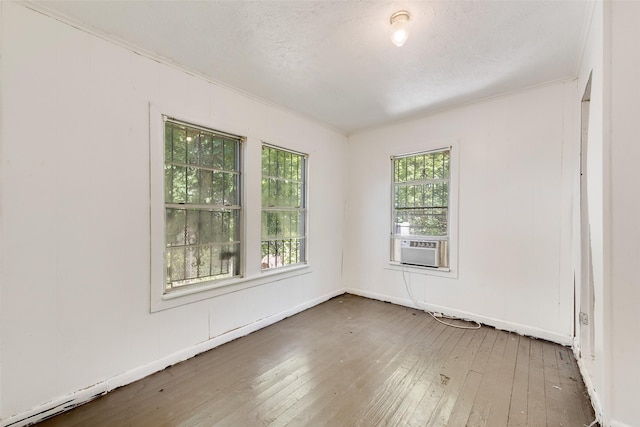 1622 Ave B, Dallas, TX 75203 - unfurnished room with hardwood / wood-style flooring, ornamental molding, cooling unit, and baseboards
