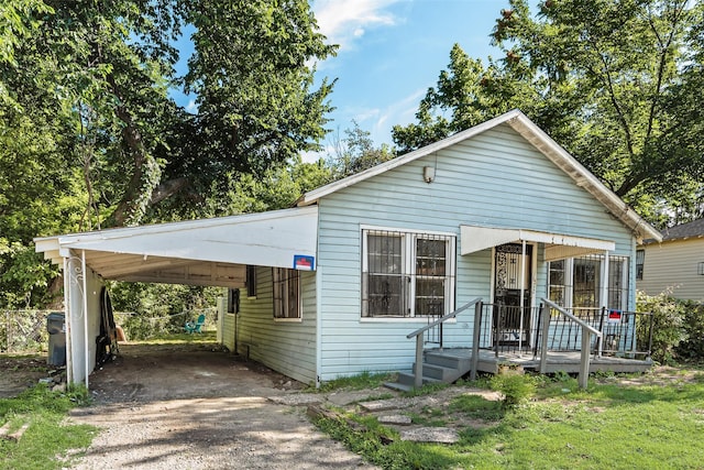 1622 Ave B, Dallas, TX 75203 - view of front facade with driveway and an attached carport