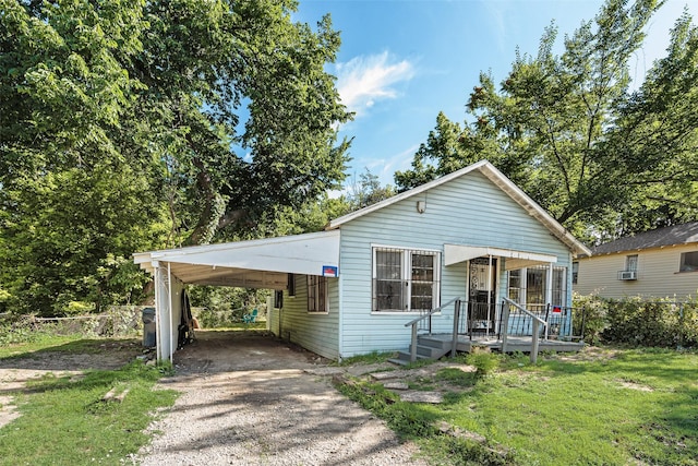 1622 Ave B, Dallas, TX 75203 - view of front of home featuring dirt driveway, an attached carport, and a front lawn