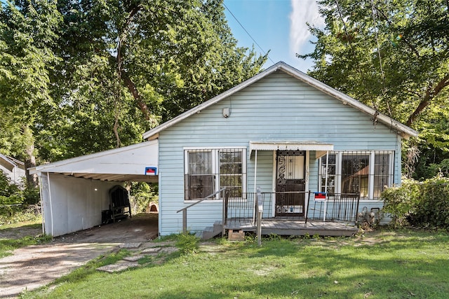 1622 Ave B, Dallas, TX 75203 - view of front of property with asphalt driveway, a carport, and a front yard