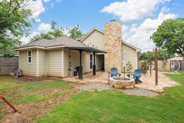 9359 W 5th St, Crawford, TX 76638 - back of property with a patio, a fire pit, and a chimney