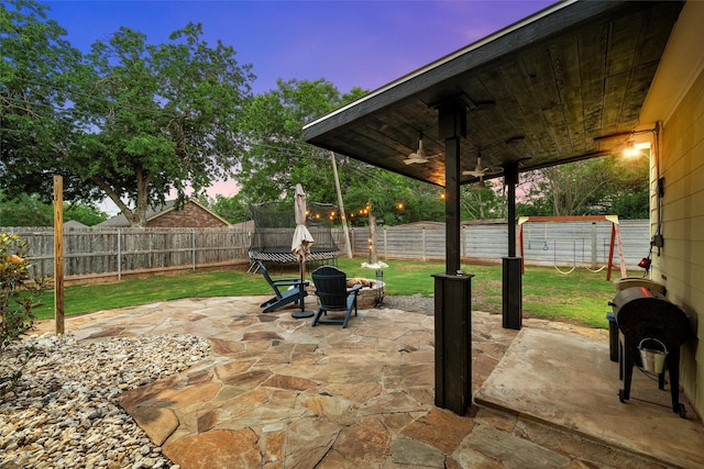 9359 W 5th St, Crawford, TX 76638 - patio terrace at dusk featuring a patio and a trampoline