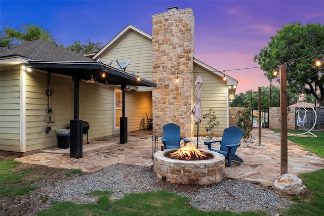 9359 W 5th St, Crawford, TX 76638 - back of property featuring an outdoor fire pit, a patio, and a chimney