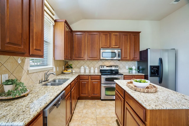 2813 Fordham Rd, Plano, TX 75025 - kitchen with appliances with stainless steel finishes, a sink, light stone counters, lofted ceiling, and a kitchen island