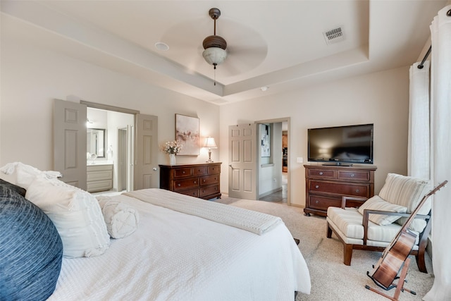 7704 Michael Ct, Mckinney, TX 75071 - bedroom with a raised ceiling, light colored carpet, connected bathroom, and ceiling fan