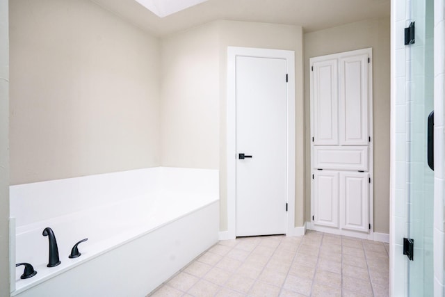 1202 Bayshore Dr, Rockwall, TX 75087 - full bath featuring a skylight, a garden tub, tile patterned flooring, a shower stall, and baseboards