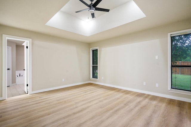 1202 Bayshore Dr, Rockwall, TX 75087 - spare room with a ceiling fan, light wood-style floors, and baseboards
