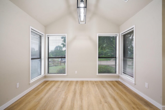 1202 Bayshore Dr, Rockwall, TX 75087 - empty room featuring lofted ceiling, wood finished floors, and baseboards