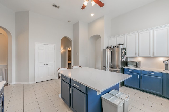 941 Sequoia Way, Saginaw, TX 76131 - kitchen with arched walkways, a ceiling fan, freestanding refrigerator, light tile patterned floors, and a towering ceiling