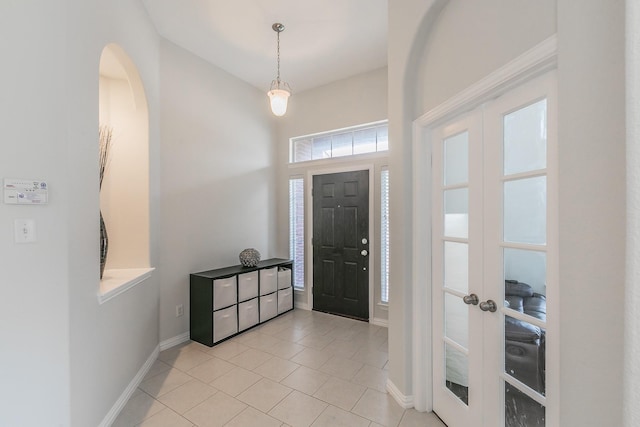 941 Sequoia Way, Saginaw, TX 76131 - foyer featuring baseboards, light tile patterned flooring, arched walkways, and french doors
