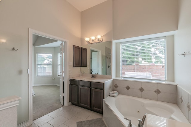 941 Sequoia Way, Saginaw, TX 76131 - bathroom with healthy amount of natural light, a jetted tub, tile patterned floors, vanity, and a high ceiling