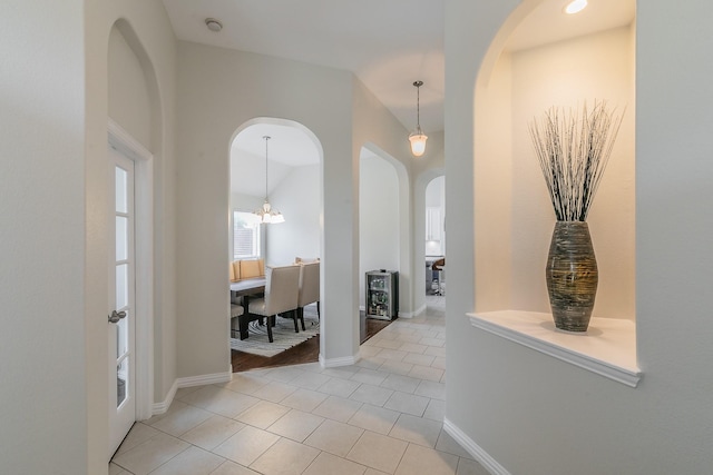 941 Sequoia Way, Saginaw, TX 76131 - entrance foyer featuring arched walkways, light tile patterned floors, a chandelier, and baseboards