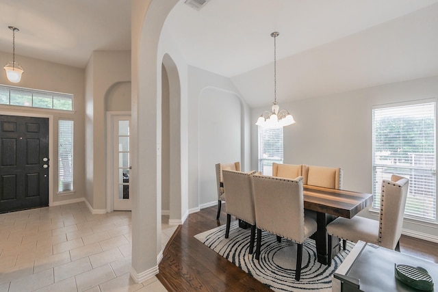 941 Sequoia Way, Saginaw, TX 76131 - dining space with arched walkways, healthy amount of natural light, a chandelier, baseboards, and lofted ceiling