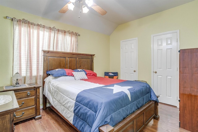 bedroom featuring lofted ceiling, light wood-type flooring, and ceiling fan