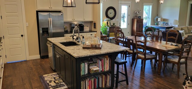 413 Prairie Crk, Sulphur Springs, TX 75482 - kitchen with a sink, dark wood-style floors, light stone countertops, open floor plan, and white cabinetry