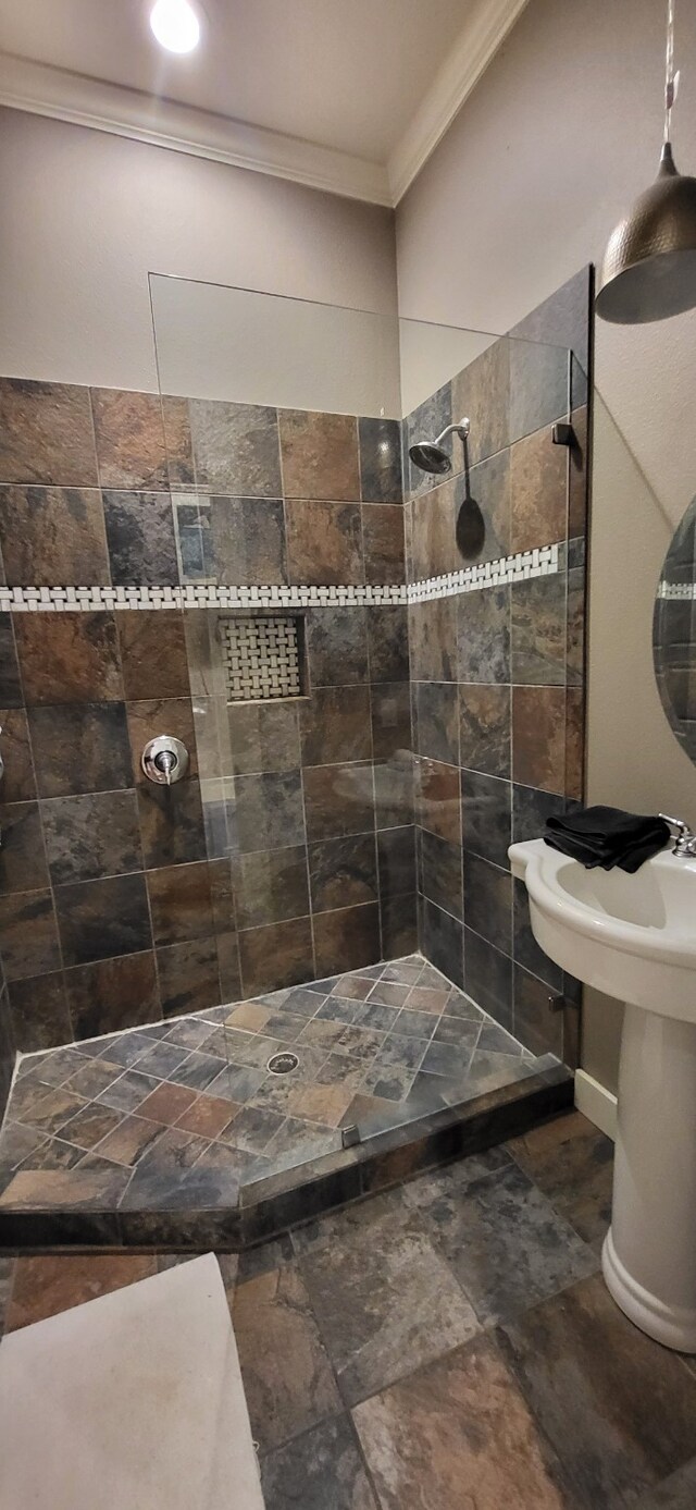 413 Prairie Crk, Sulphur Springs, TX 75482 - bathroom with crown molding, a tile shower, and stone finish flooring