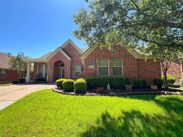 6869 Cape Cod Dr, Grand Prairie, TX 75054 - view of front of home with brick siding and a front lawn