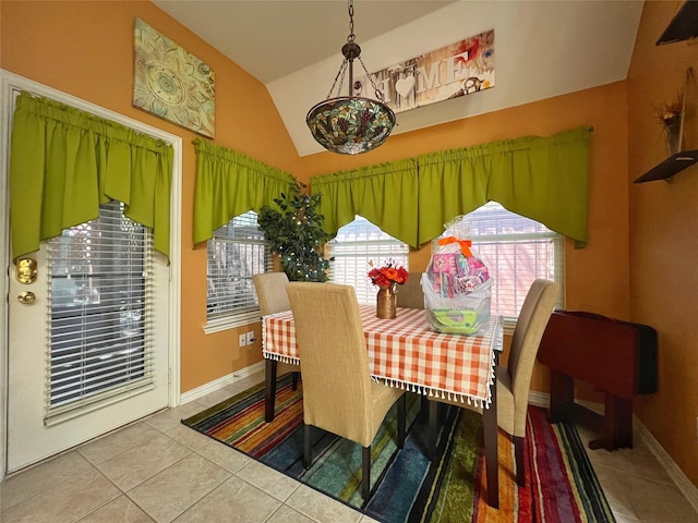 6869 Cape Cod Dr, Grand Prairie, TX 75054 - tiled dining room with lofted ceiling and baseboards