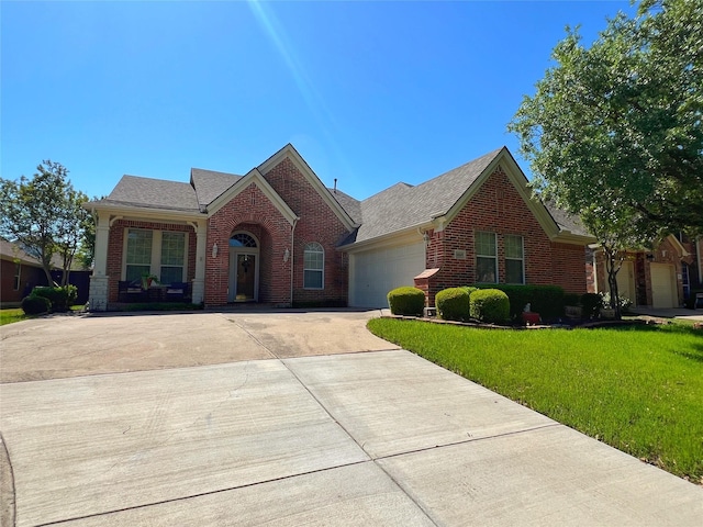 6869 Cape Cod Dr, Grand Prairie, TX 75054 - traditional-style house featuring brick siding, driveway, a garage, a front lawn, and a shingled roof