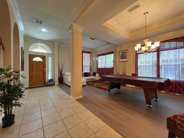 6869 Cape Cod Dr, Grand Prairie, TX 75054 - foyer entrance with crown molding, pool table, light wood-style floors, a chandelier, and arched walkways