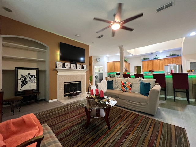 6869 Cape Cod Dr, Grand Prairie, TX 75054 - living room featuring ceiling fan, a tile fireplace, built in features, recessed lighting, and light wood-style floors