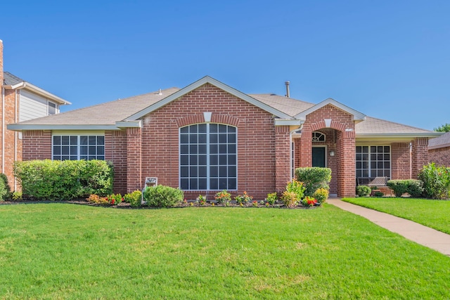 5704 Poole Dr, The Colony, TX 75056 - ranch-style house with brick siding, a front yard, and a shingled roof