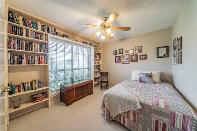 5704 Poole Dr, The Colony, TX 75056 - bedroom featuring carpet, a textured ceiling, and a ceiling fan