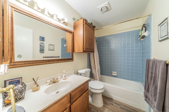 5704 Poole Dr, The Colony, TX 75056 - full bath featuring vanity, toilet, wood finished floors, shower / bath combination with curtain, and a textured ceiling