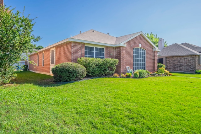 5704 Poole Dr, The Colony, TX 75056 - view of side of property featuring a yard and brick siding