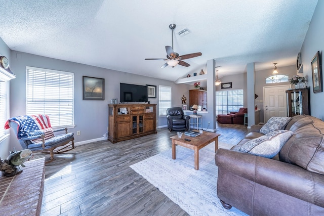 5704 Poole Dr, The Colony, TX 75056 - living area with wood finished floors, a textured ceiling, ceiling fan, lofted ceiling, and baseboards