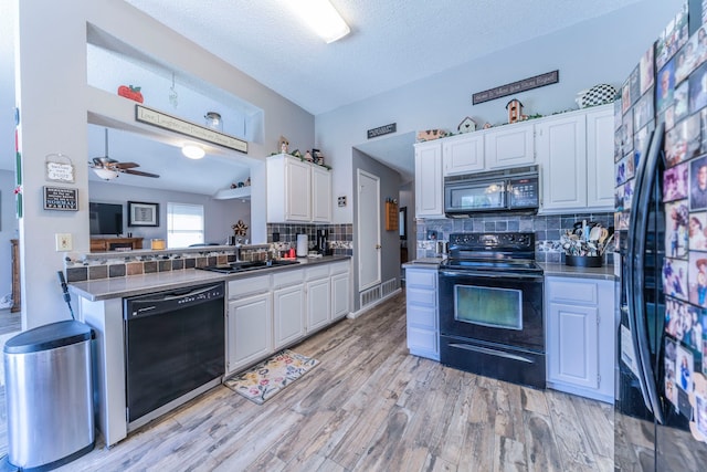 5704 Poole Dr, The Colony, TX 75056 - kitchen with black appliances, a sink, white cabinetry, tasteful backsplash, and a textured ceiling