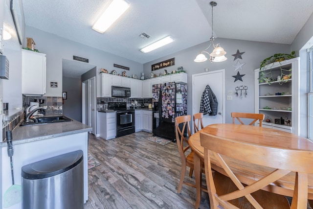 5704 Poole Dr, The Colony, TX 75056 - kitchen with black appliances, a sink, light wood finished floors, decorative backsplash, and white cabinetry