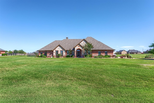 1777 Lone Star Blvd, Terrell, TX 75160 - view of front of house with a front lawn, a chimney, stone siding, and brick siding