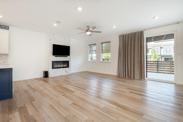 913 Emerling Dr, Mckinney, TX 75069 - unfurnished living room with a ceiling fan, light wood-type flooring, a premium fireplace, recessed lighting, and baseboards