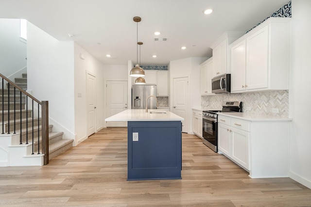 913 Emerling Dr, Mckinney, TX 75069 - kitchen featuring appliances with stainless steel finishes, a sink, white cabinets, tasteful backsplash, and recessed lighting